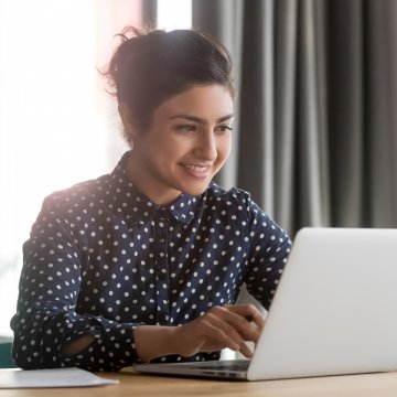 Woman at a laptop smiling